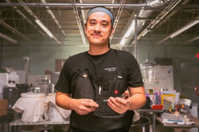 A person serving an ice cream cone. 